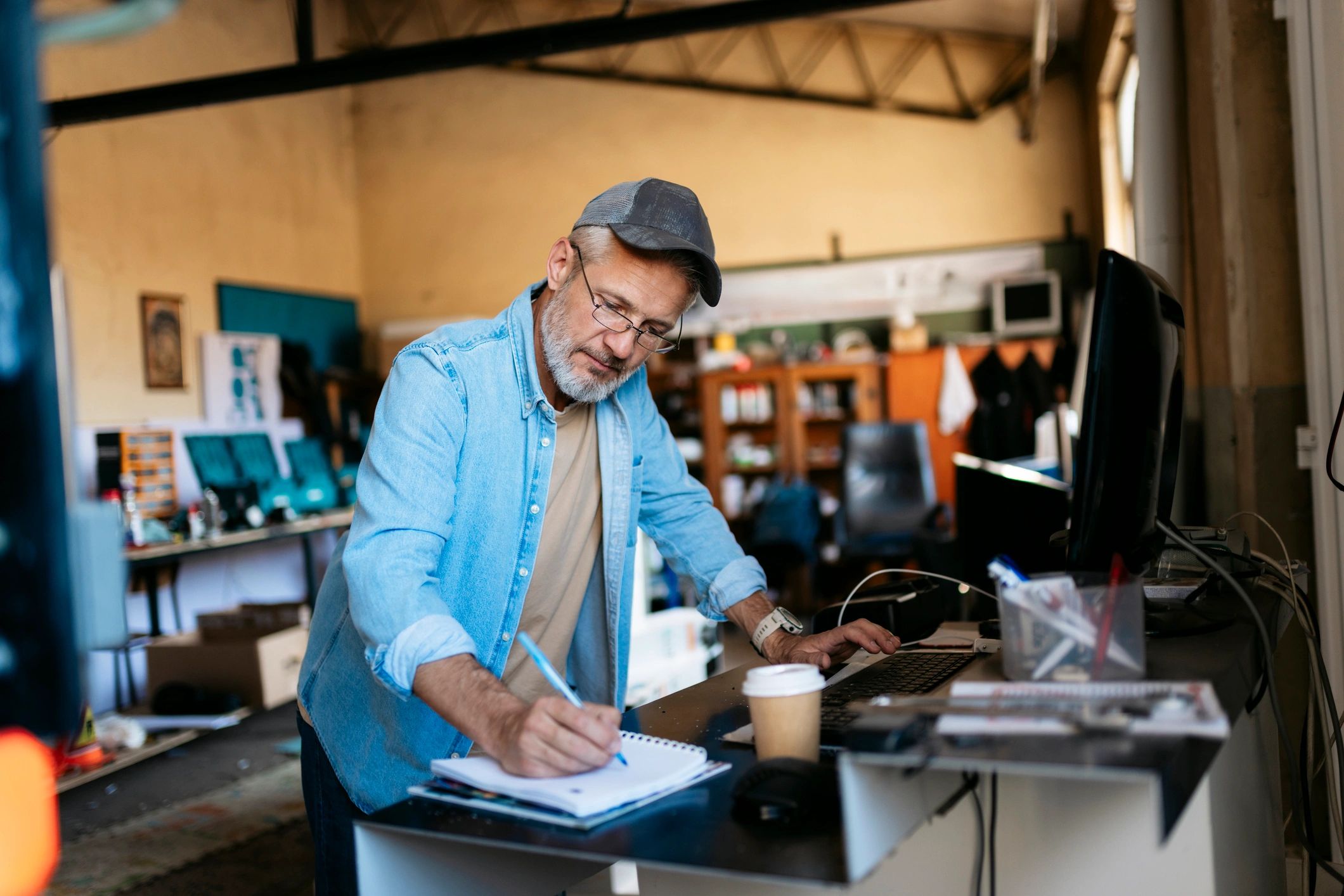 Small business owner reviewing invoices and notes at a desk
